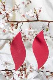A model wearing size OneSize of the Australian Made Bold Single Leaf Leather Earring in colour Fuschia (Pink), from the front, showing the whole outfit