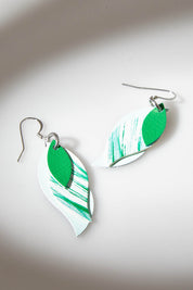 A model wearing size OneSize of the Australian Made Brushed Leather Leaf Earring in colour Green (Green), from the front, showing the whole outfit