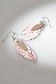 A model wearing size OneSize of the Australian Made Brushed Leather Leaf Earring in colour Softpink (Pink), from the front, showing the whole outfit