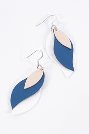 A model wearing size OneSize of the Australian Made Large Leather Leaf Earring in colour Beigenavy (Blue), from the front, showing the whole outfit