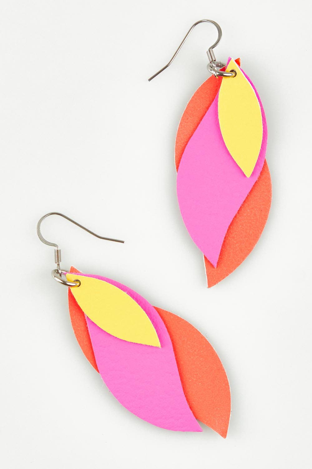 A model wearing size OneSize of the Australian Made Large Leather Leaf Earring in colour Orangepink (Pink), from the front, showing the whole outfit