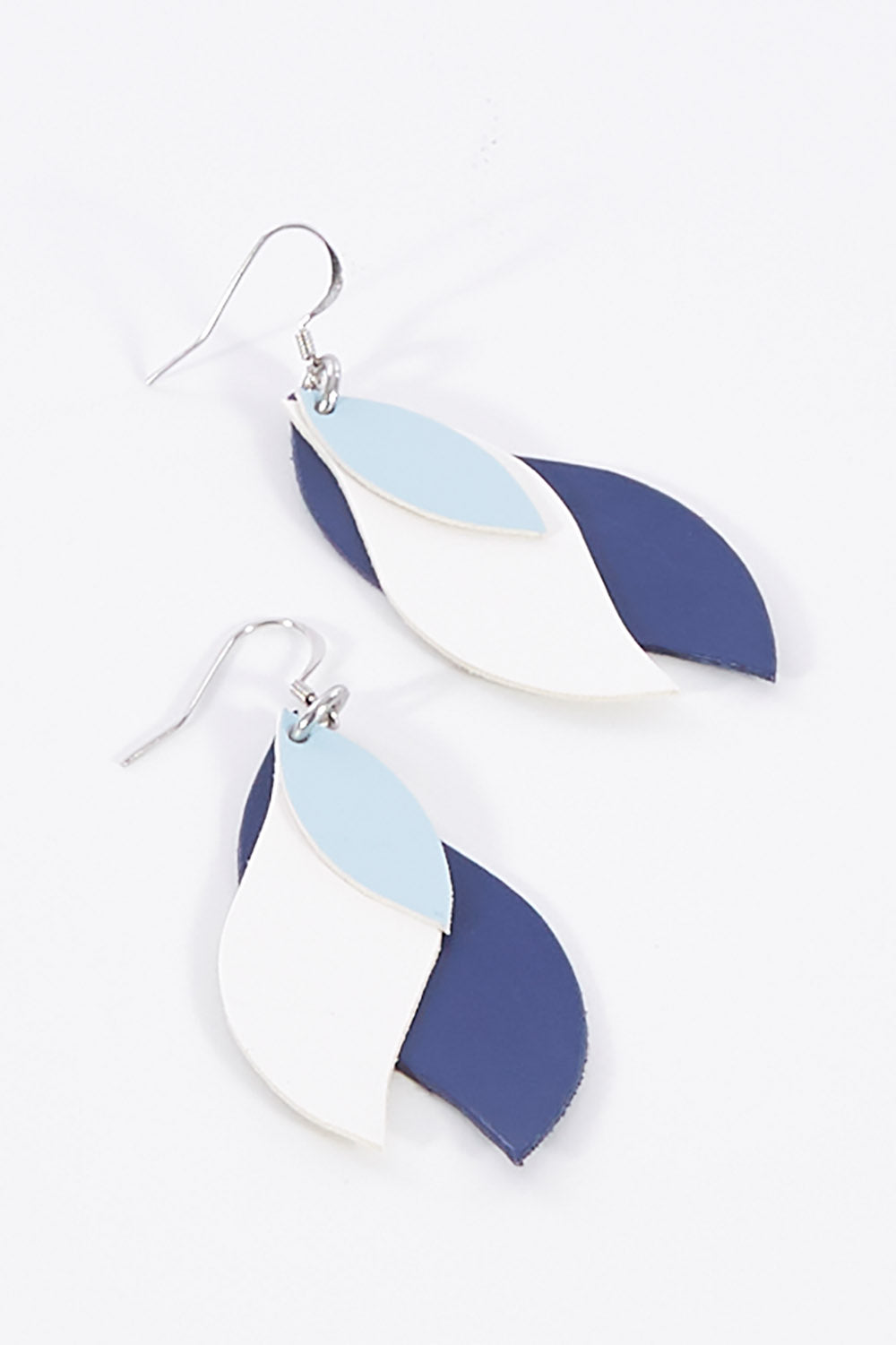 A model wearing size OneSize of the Australian Made Large Leather Leaf Earring in colour Powderwhit (Blue), from the front, showing the whole outfit