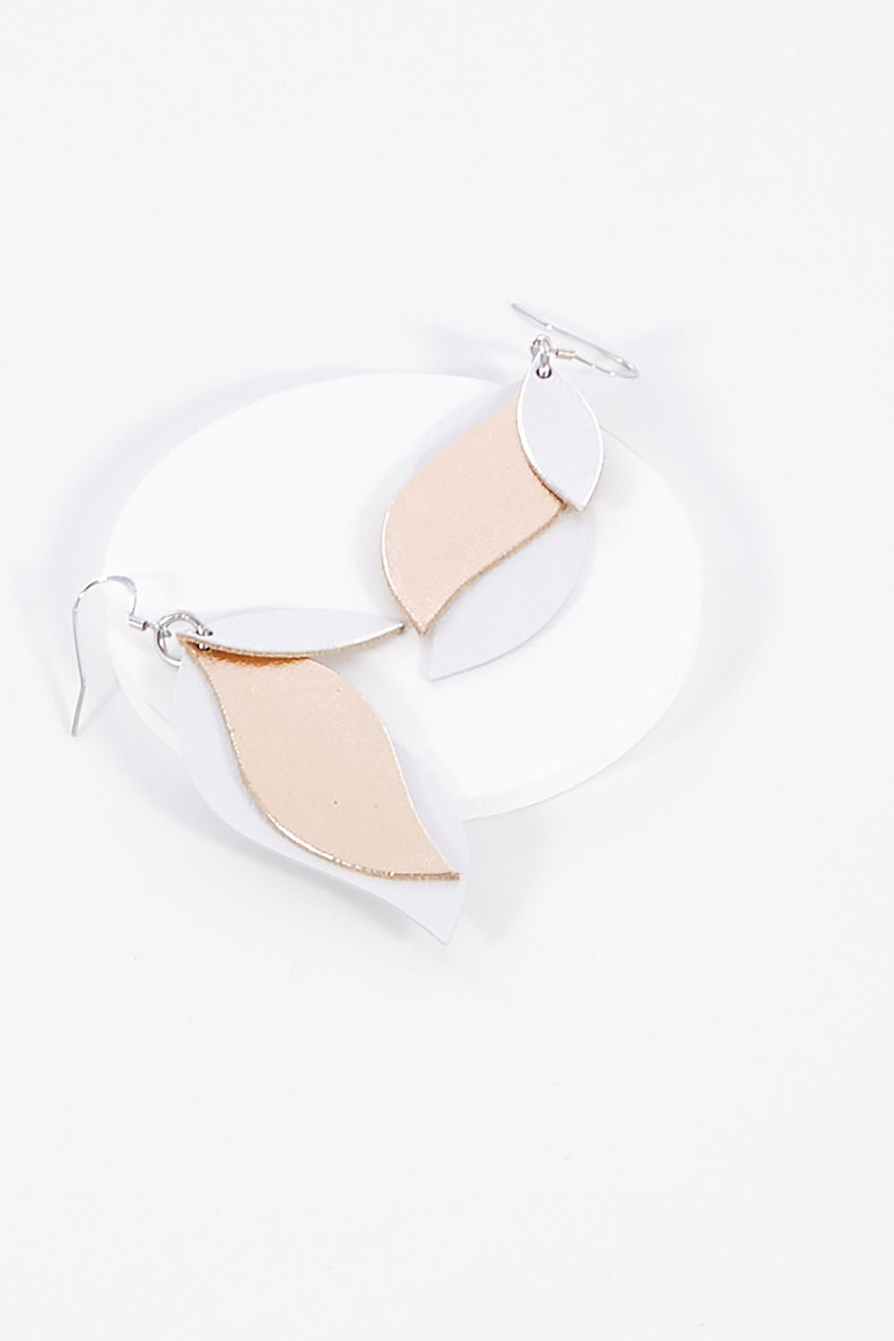 A model wearing size OneSize of the Australian Made Large Leather Leaf Earring in colour Silveroseg (Metallics), from the front, showing the whole outfit