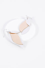 A model wearing size OneSize of the Australian Made Large Leather Leaf Earring in colour Silveroseg (Metallics), from the front, showing the whole outfit