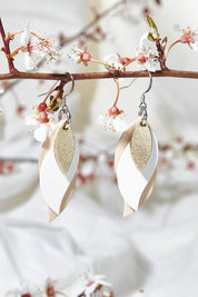 A model wearing size OneSize of the Australian Made Leather Leaf Earring in colour Goldwhite (Metallics), from the front, showing the whole outfit