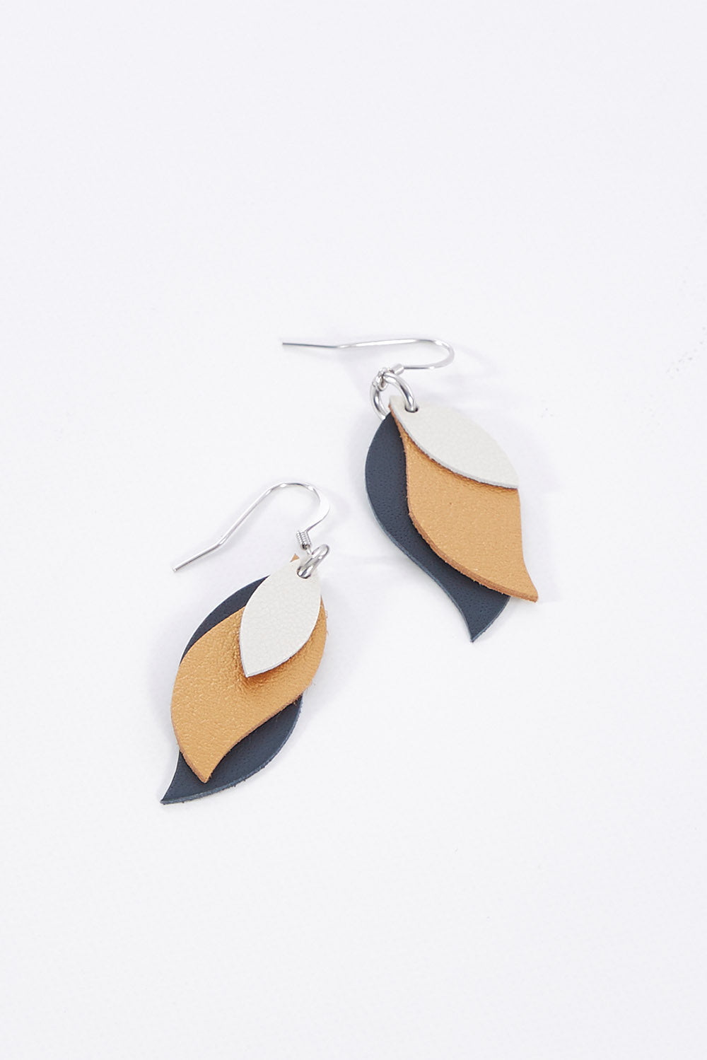 A model wearing size OneSize of the Australian Made Leather Leaf Earring in colour Ivorygold (Metallics), from the front, showing the whole outfit