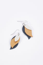 A model wearing size OneSize of the Australian Made Leather Leaf Earring in colour Ivorygold (Metallics), from the front, showing the whole outfit