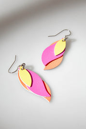 A model wearing size OneSize of the Australian Made Leather Leaf Earring in colour Orapinkyel (Pink), from the front, showing the whole outfit