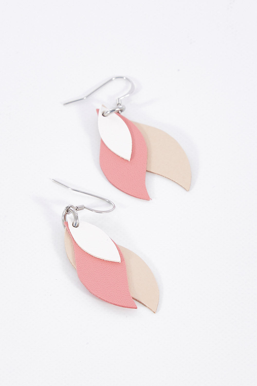 A model wearing size OneSize of the Australian Made Leather Leaf Earring in colour Whitepink (Pink), from the front, showing the whole outfit