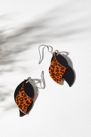 A model wearing size OneSize of the Australian Made Leather Leaf Leopard Earring in colour Blaleotan (Black), from the front, showing the whole outfit