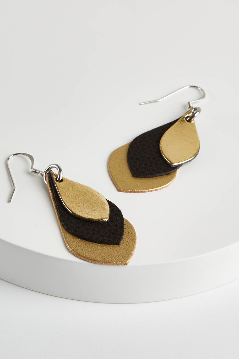 A model wearing size OneSize of the Australian Made Leather Teardrop Earring in colour Black (Black), from the front, showing the whole outfit