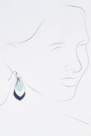 A model wearing size OneSize of the Australian Made Leather Teardrop Earring in colour Bluewhite (Blue), from the front, showing the whole outfit