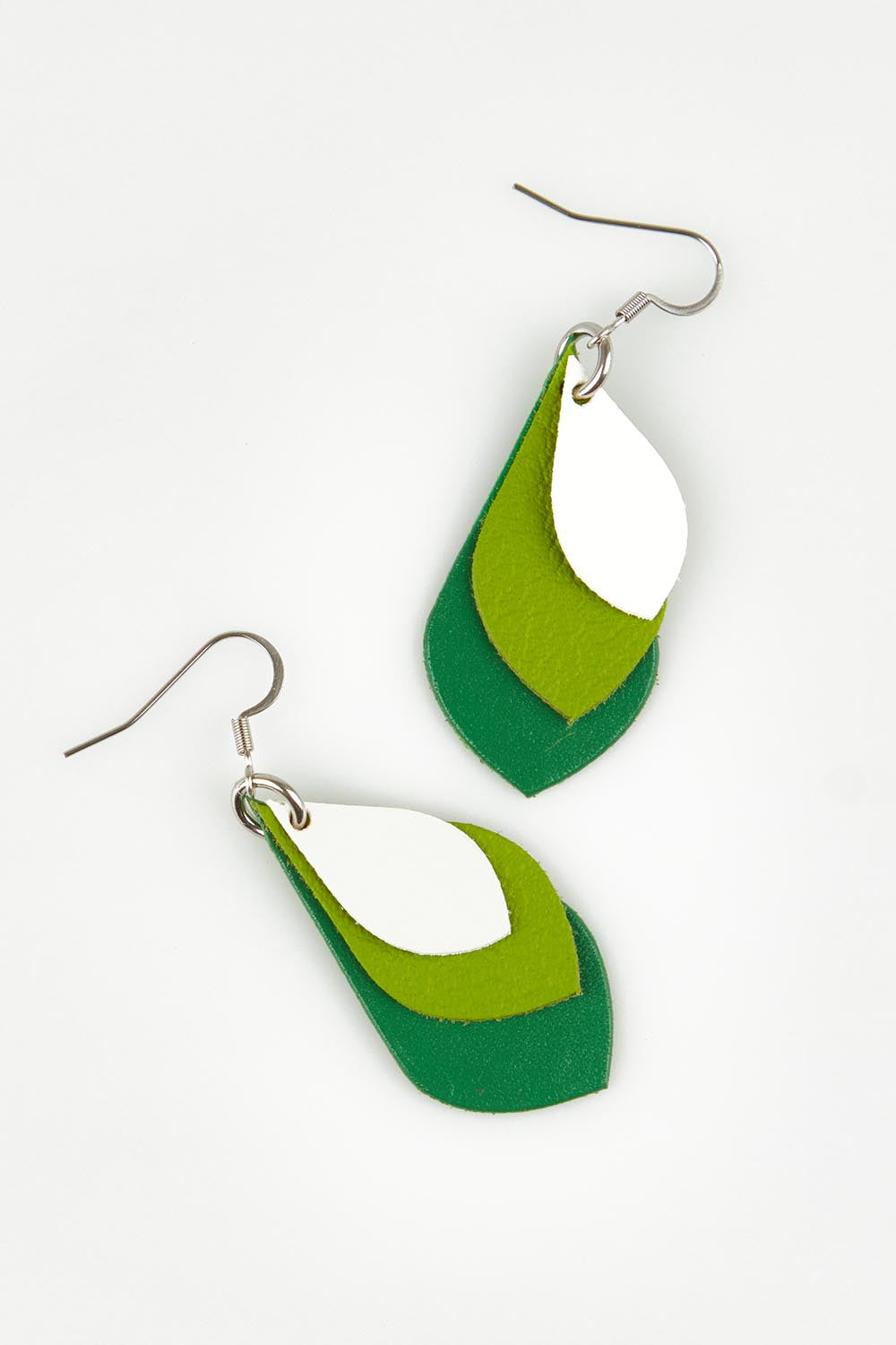 A model wearing size OneSize of the Australian Made Leather Teardrop Earring in colour Greenwhite (Green), from the front, showing the whole outfit