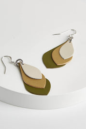A model wearing size OneSize of the Australian Made Leather Teardrop Earring in colour Olivegold (Green), from the front, showing the whole outfit