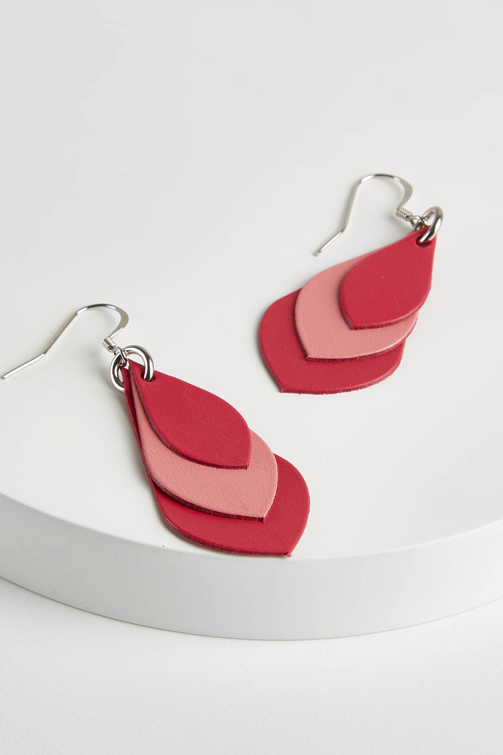 A model wearing size OneSize of the Australian Made Leather Teardrop Earring in colour Pink (Pink), from the front, showing the whole outfit