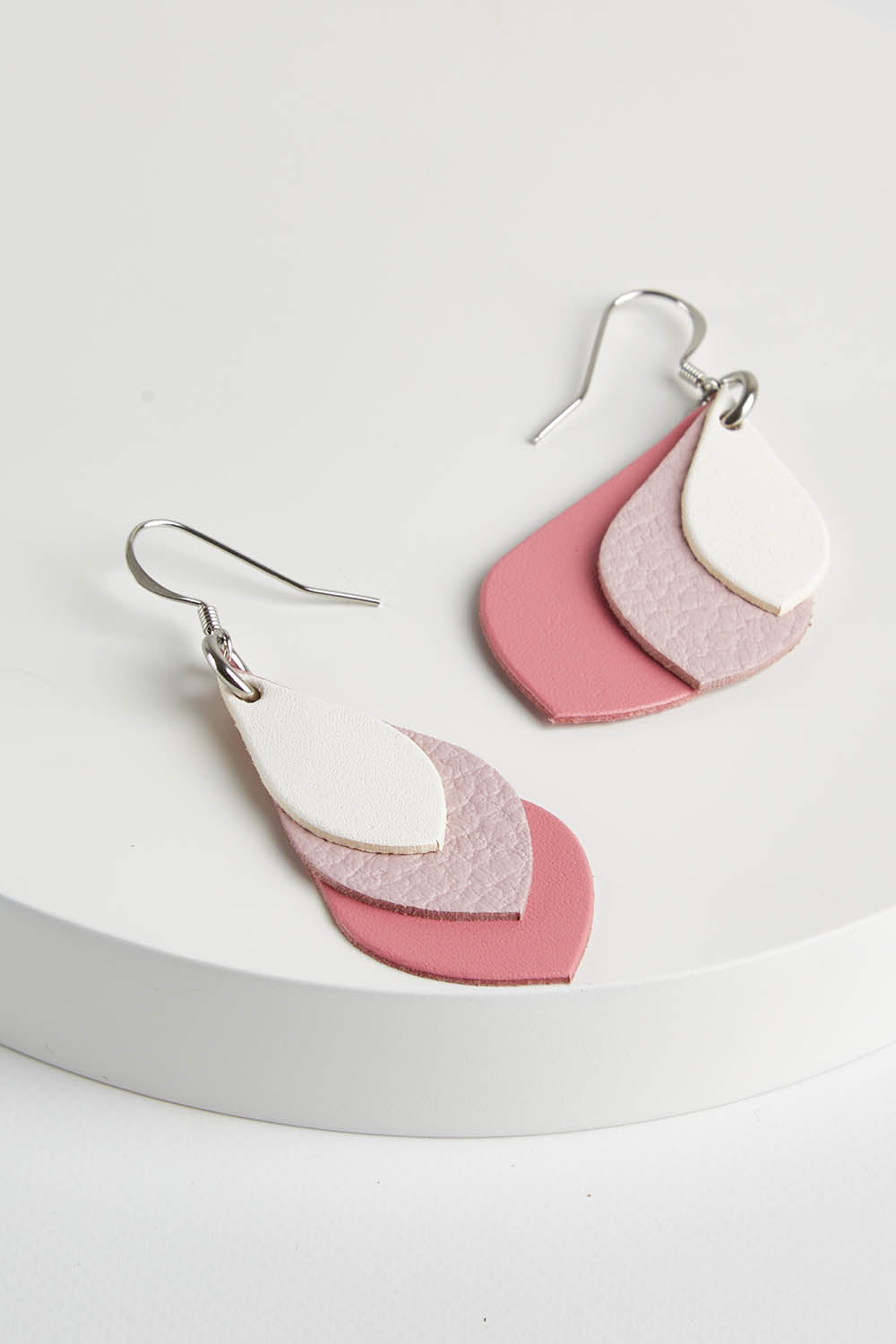 A model wearing size OneSize of the Australian Made Leather Teardrop Earring in colour Pinkwhite (Pink), from the front, showing the whole outfit