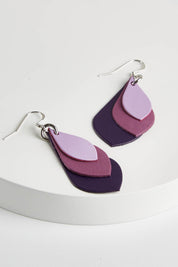 A model wearing size OneSize of the Australian Made Leather Teardrop Earring in colour Purple (Purple), from the front, showing the whole outfit