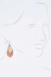 A model wearing size OneSize of the Australian Made Leather Teardrop Earring in colour Warmpink (Pink), from the front, showing the whole outfit