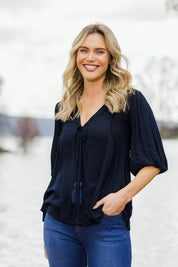 Model Alice wearing size 10 of the Drifter Top in colour Navy (Blue), from the front, showing the whole outfit
