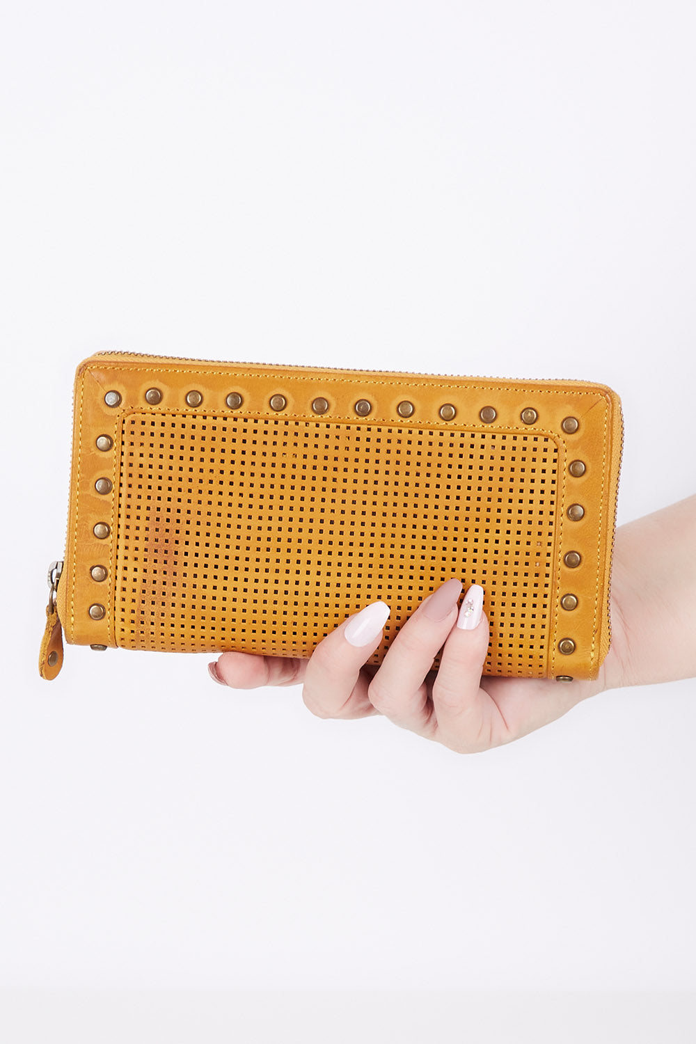 A model wearing size OneSize of the Tilly Leather Zip Around Wallet in colour Mustard, from the front, showing the whole outfit