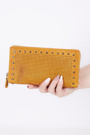 A model wearing size OneSize of the Tilly Leather Zip Around Wallet in colour Mustard, from the front, showing the whole outfit