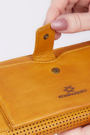 A model wearing size OneSize of the Tilly Leather Zip Around Wallet in colour Mustard, from the front, showing the whole outfit