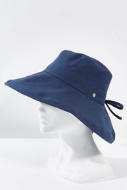 A model wearing the Ladies Upturn Noosa Hat in colour Navy (Blue), from the front, showing the whole outfit