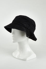 A model wearing the Tullamore Cotton Bucket Hat in colour Black (Black), from the front, showing the whole outfit