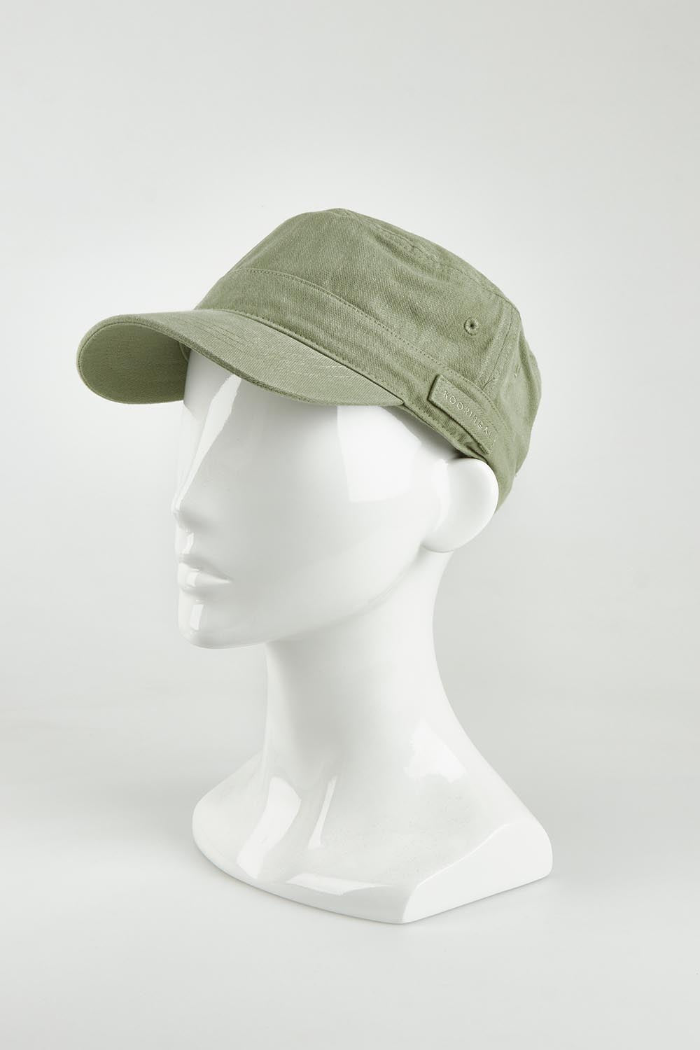 A model wearing size OneSize of the Marley Mao Cap in colour Olive (Green), from the front, showing the whole outfit