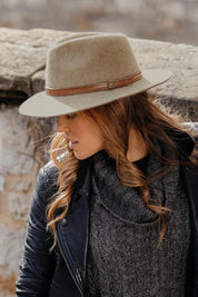 A model wearing the Kallie Merino Wool Safari Hat in colour Natural, from the front, showing the whole outfit