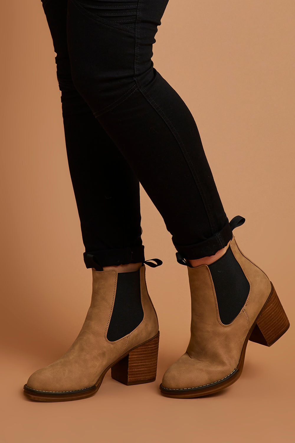 A model wearing size 38 of the Cleo Ankle Boot in colour Taupe, from the front, showing the whole outfit