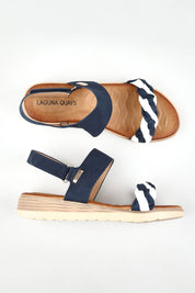 A model wearing size 37 of the Fari Sandal in colour Navywhite (Blue), from the front, showing the whole outfit