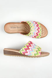 A model wearing size 37 of the Ganni Slide in colour Brightmult (Pink), from the front, showing the whole outfit