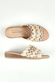 A model wearing size 37 of the Ganni Slide in colour Natural, from the front, showing the whole outfit