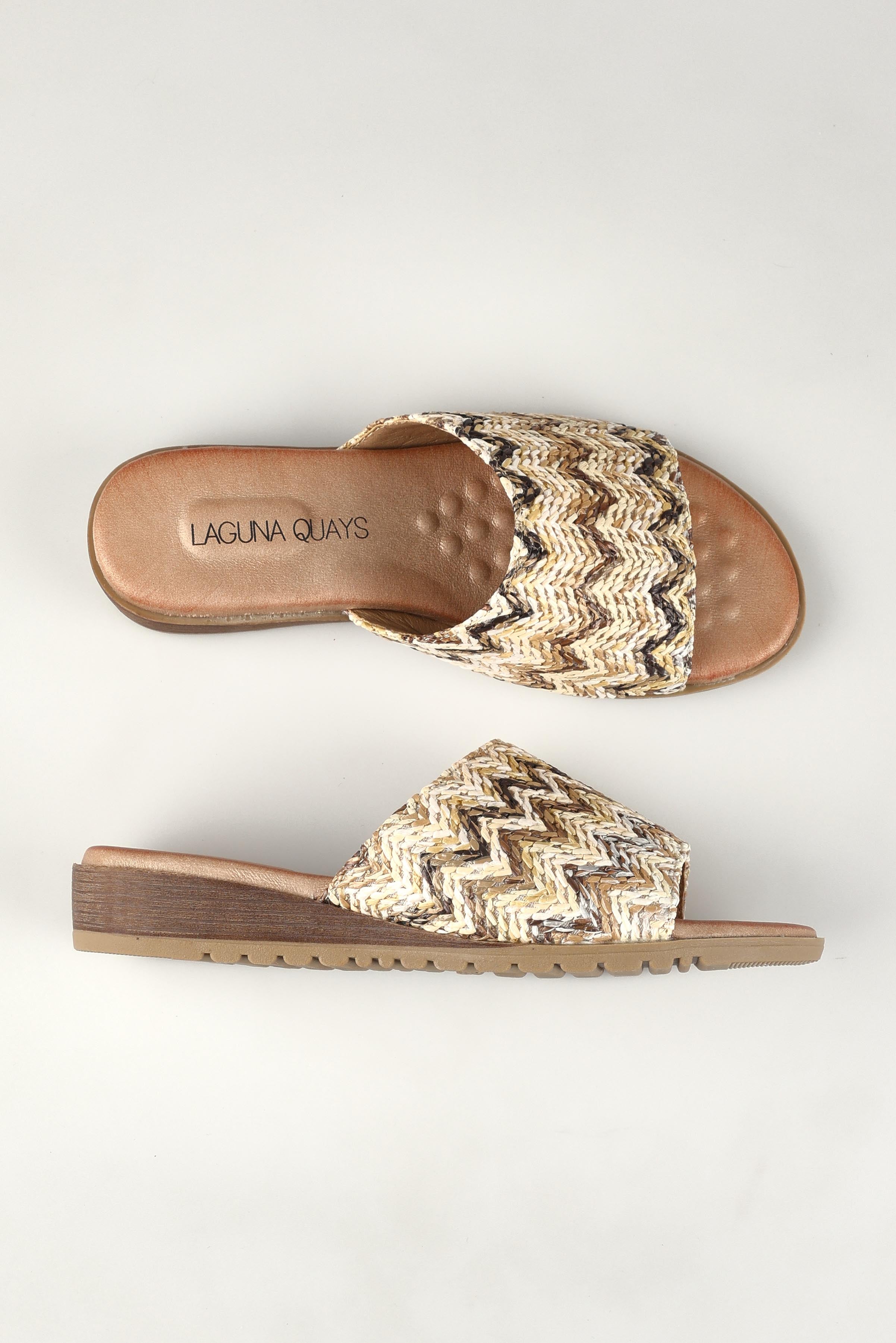 A model wearing the Ganni Slide in colour Natural, from the front, showing the whole outfit