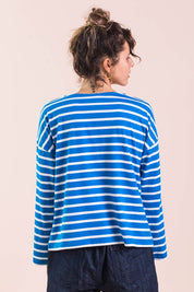 A model wearing the Brigitte Tee in colour Cobalt (Blue), from the back