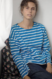 A model wearing the Brigitte Tee in colour Cobalt (Blue), from the front, showing the whole outfit