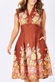 Model Laura wearing size L of the Stephanie Dress in colour Anise, from the front, cropped image