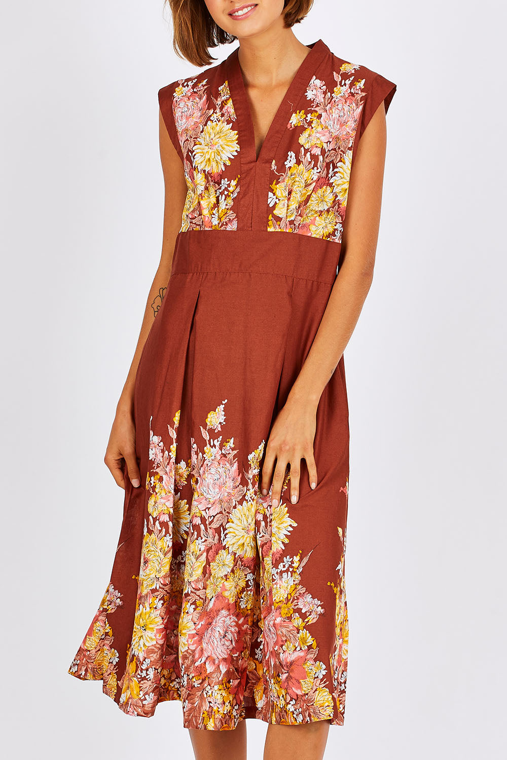 Model Nikki wearing size S of the Stephanie Dress in colour Anise, from the front, cropped image