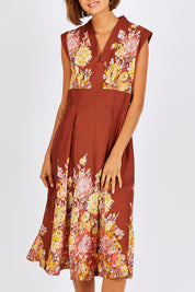 Model Nikki wearing size S of the Stephanie Dress in colour Anise, from the front, cropped image