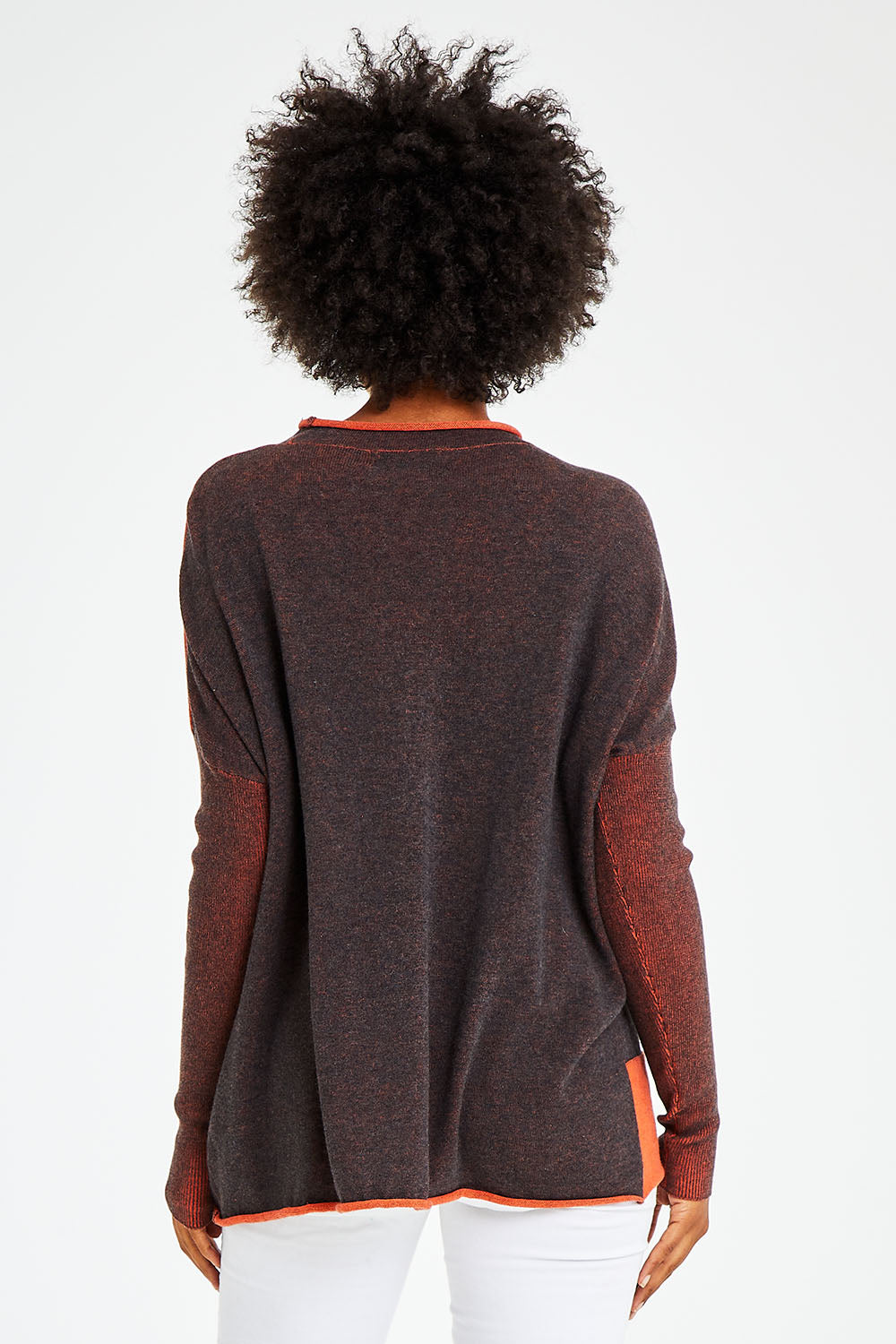 Model Olivia wearing size S of the Plaited Funnel Jumper in colour Amber, from the back