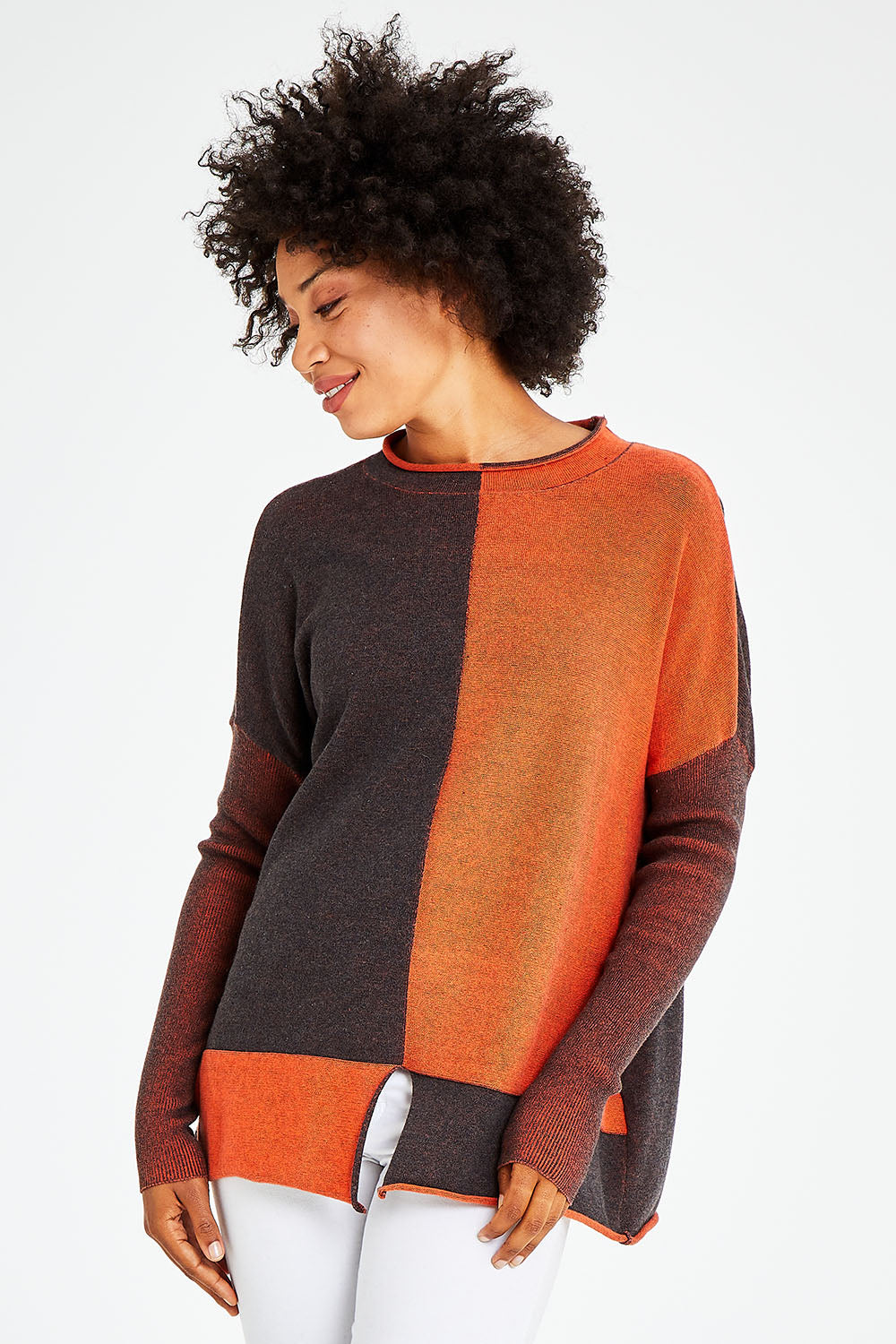 Model Olivia wearing size S of the Plaited Funnel Jumper in colour Amber, from the front, cropped image