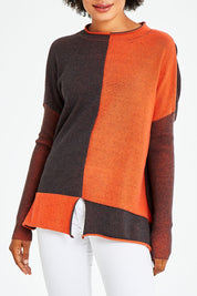 Model Olivia wearing size S of the Plaited Funnel Jumper in colour Amber, from the front, cropped image
