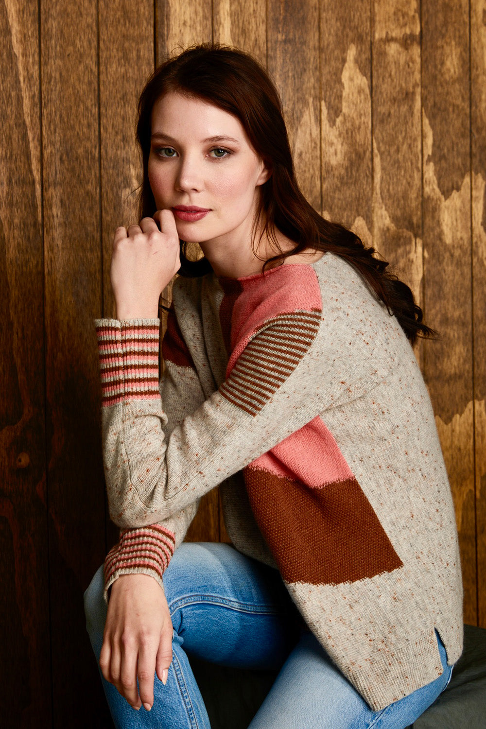A model wearing the Whirlwind Jumper in colour Earth, from the front, showing the whole outfit