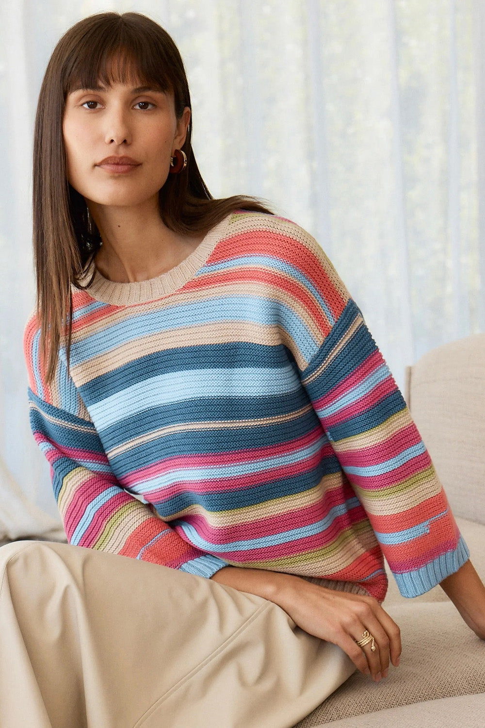 A model wearing the Multi Stripe Cotton Blend Jumper in colour Oat, from the front, showing the whole outfit