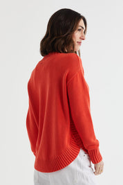 A model wearing the Cotton Mock Turtle in colour Persimmon, from the back