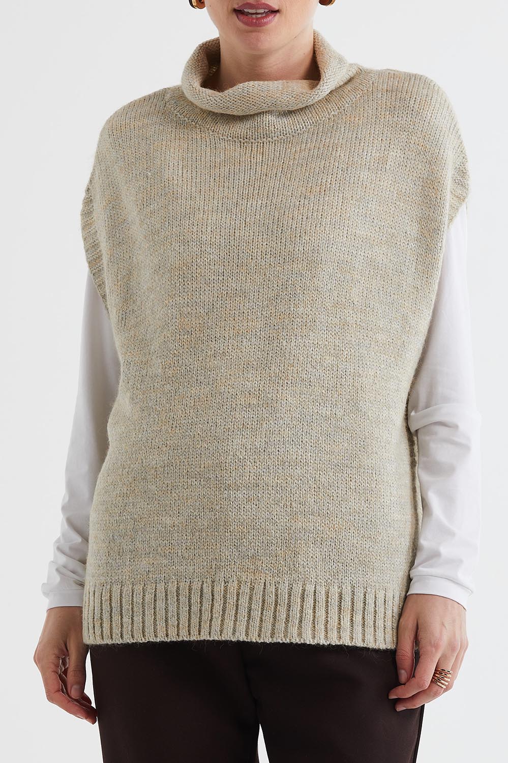 A model wearing the Lofty Tunic in colour Oat, from the front, cropped image