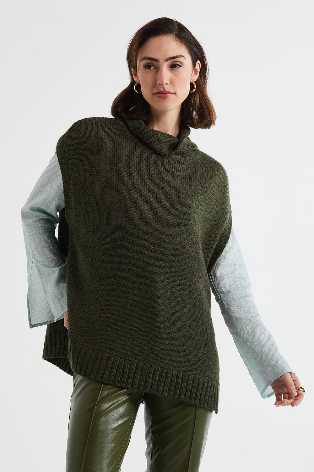 A model wearing the Lofty Tunic in colour Olive (Green), from the front, cropped image