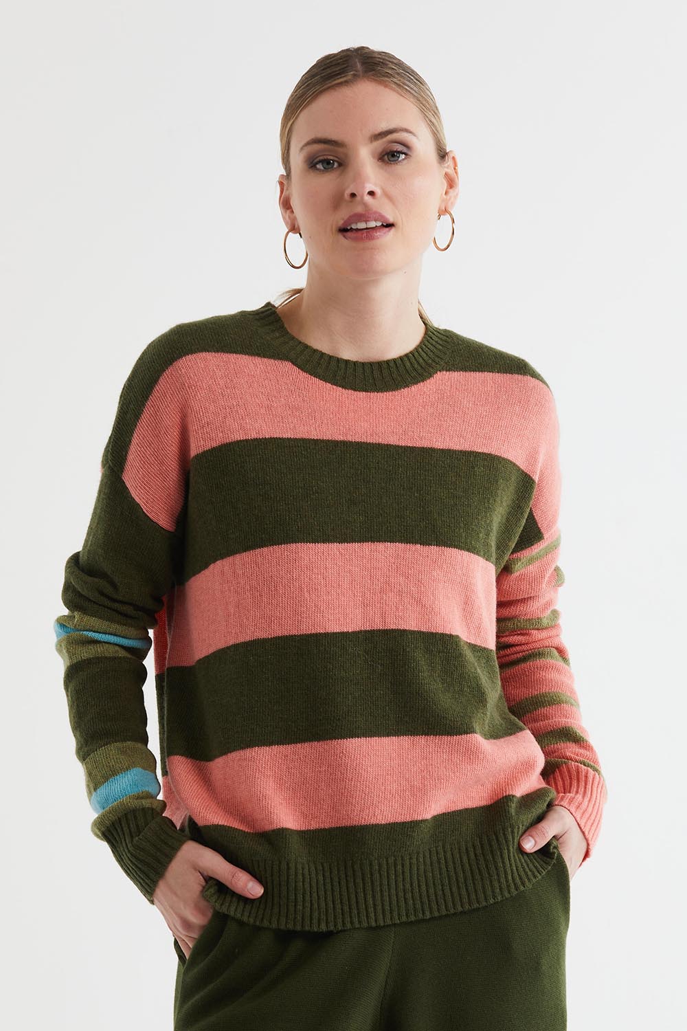 A model wearing the Lambswool Stripe Crew in colour Olive, from the front, cropped image