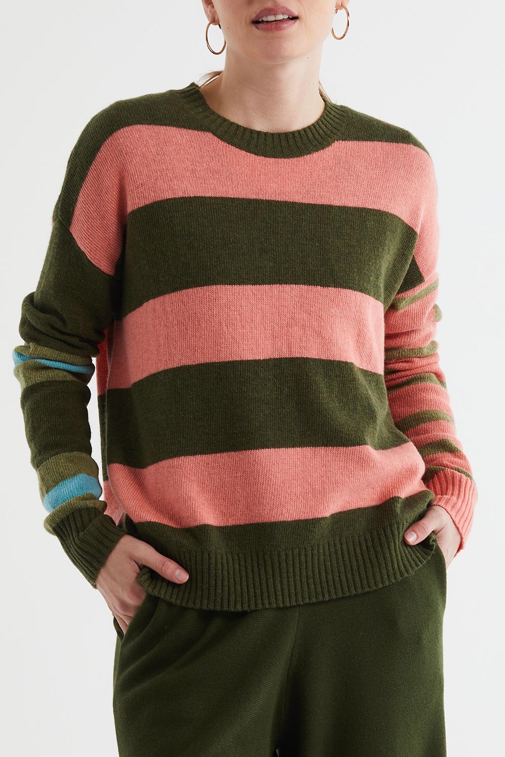A model wearing the Lambswool Stripe Crew in colour Olive, from the front, cropped image